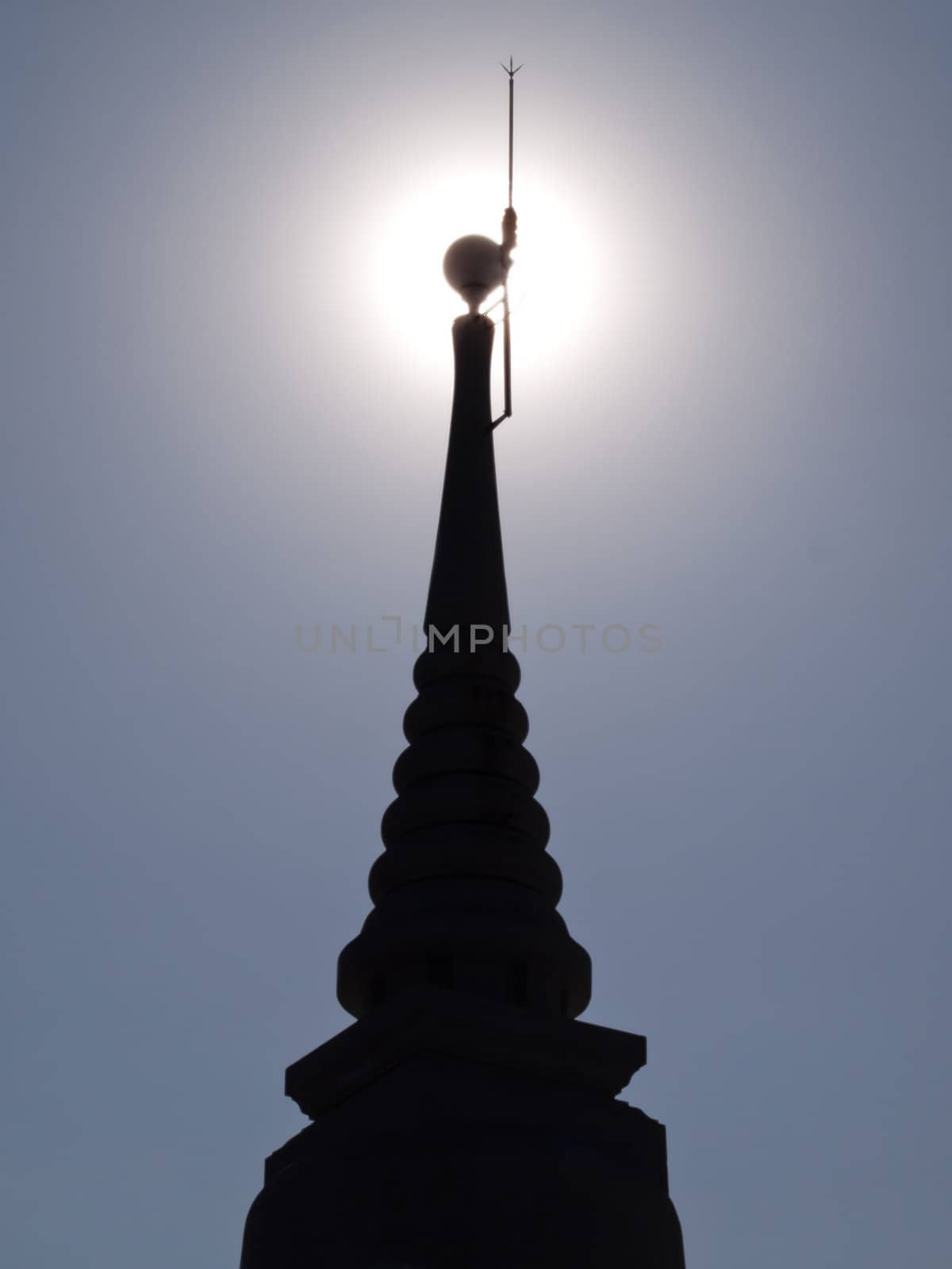 Silhouette of pagoda with sun on top