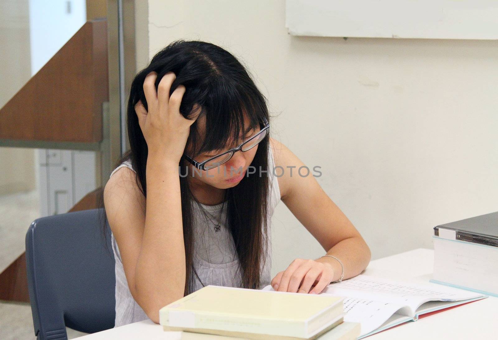 Asian girl student reading and studying in library by kawing921