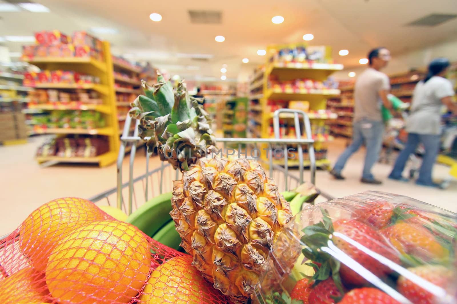 Moving shopping cart in supermarket. It was taken from the shopper's point of view.