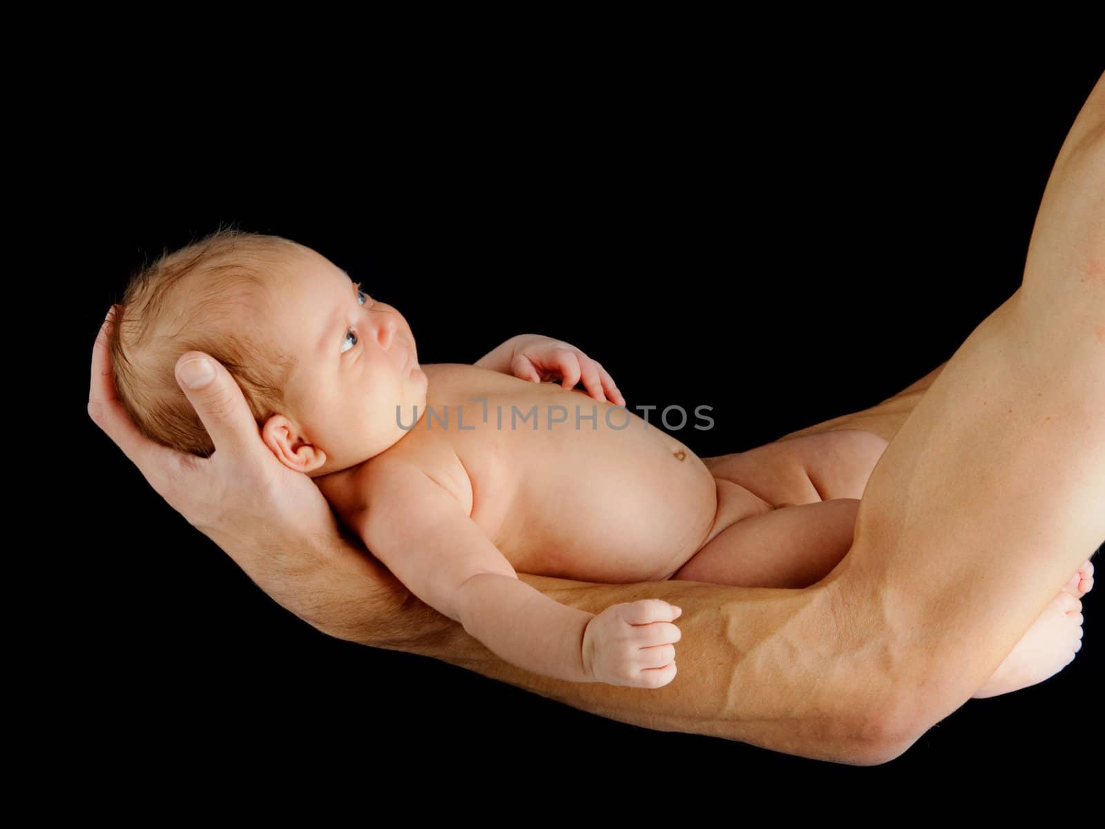 Father holding newborn baby by maxoliki