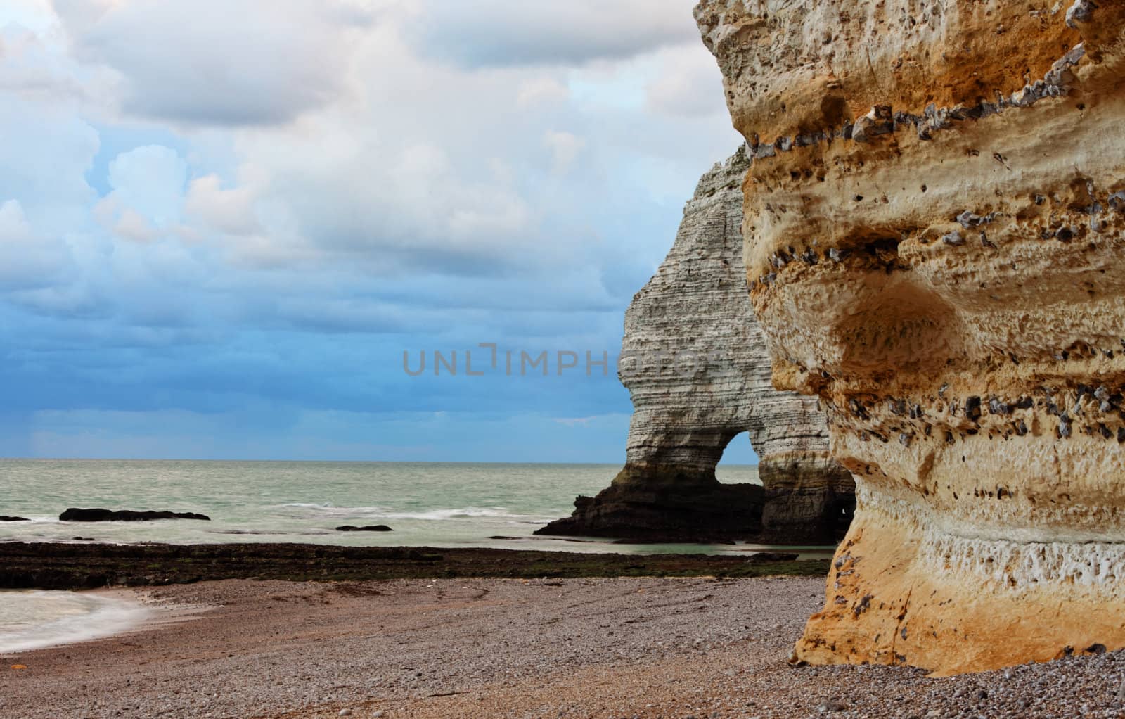 Image of stones and ocean.Location: La Falaise d'Amont in Etretat on the Upper Normandy coast in the North of France.