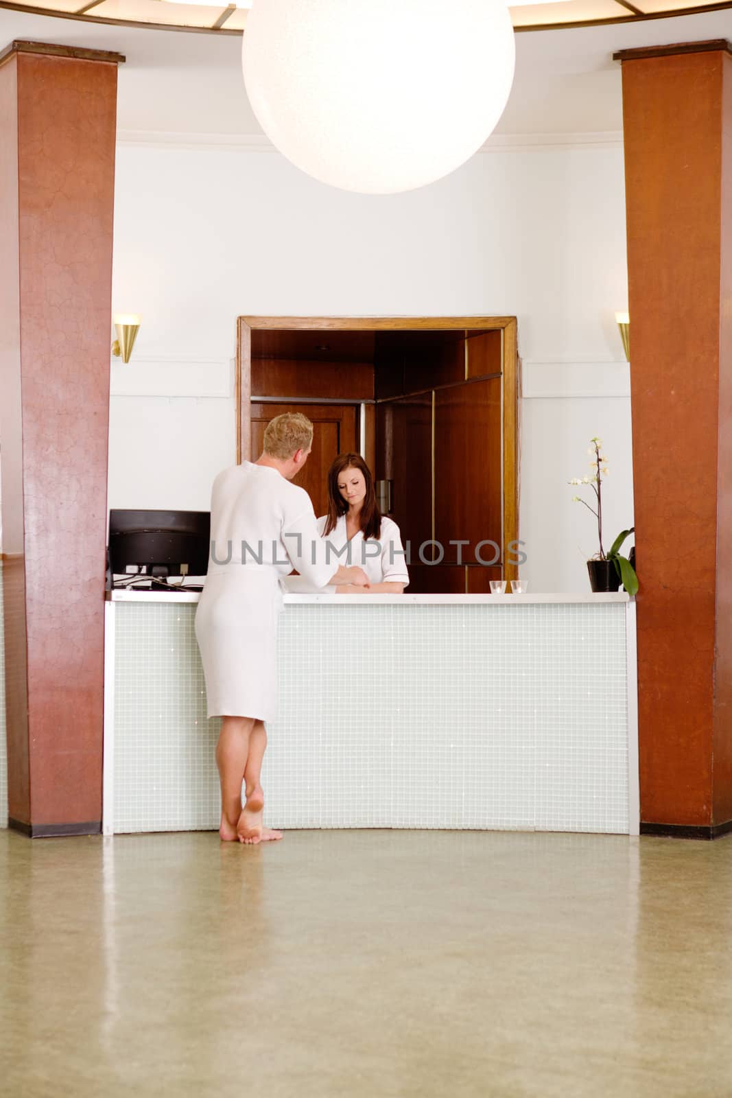 A functionalism (funkis) spa interior with a man choosing a therapy package