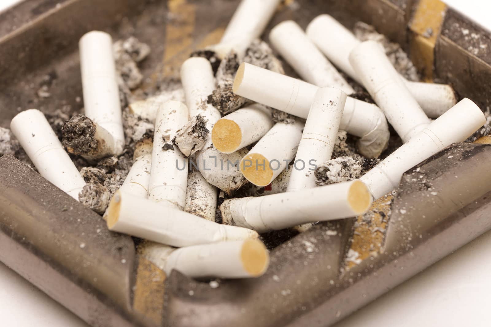 photo of ashtray with butts, closeup