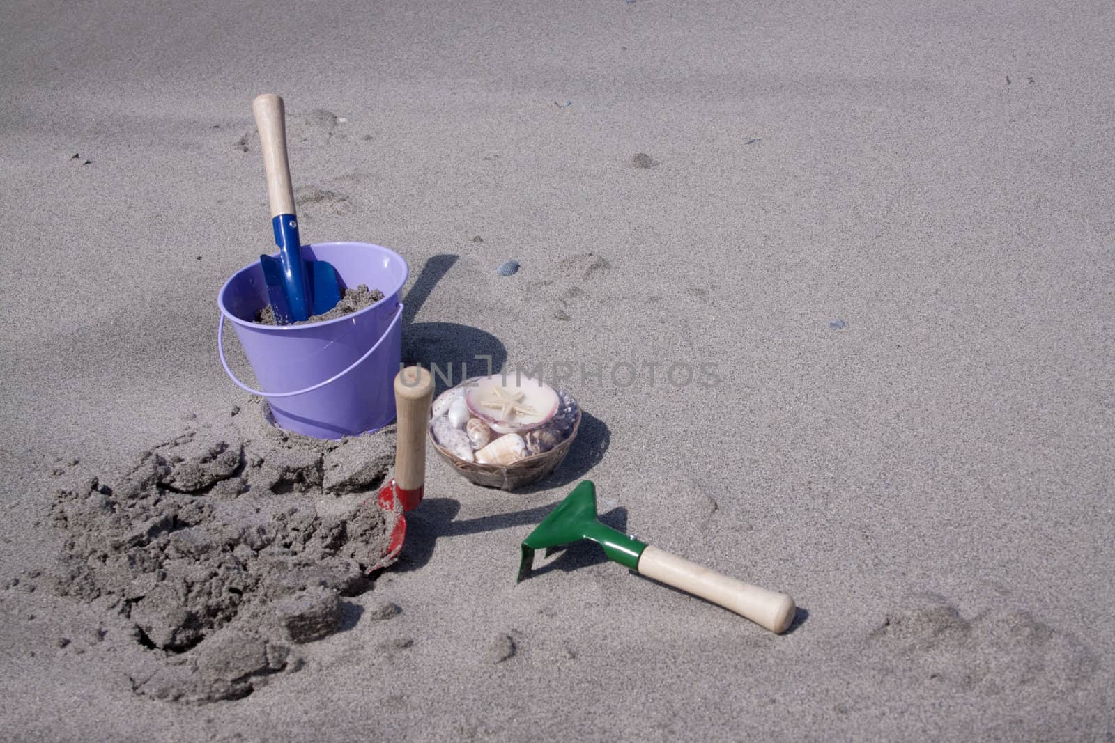 Toy-buckets in the sand on the beach 