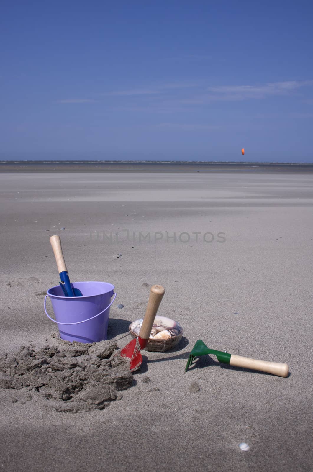 Toy-buckets in the sand on the beach 
