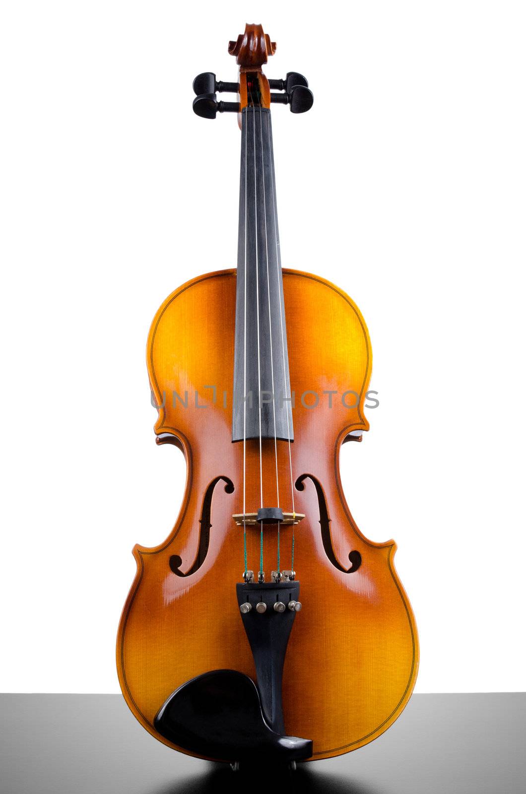 Violin on top of dark table ppartially isolated on white background.