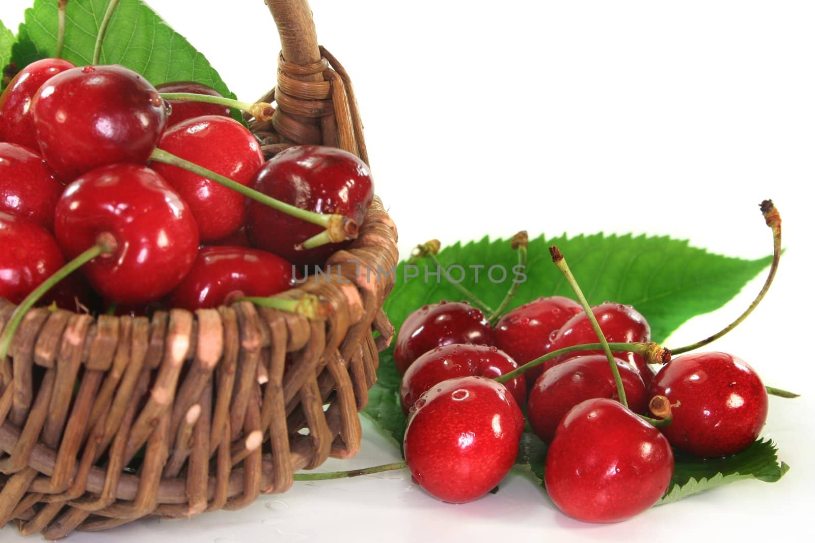 a basket filled with fresh red cherries