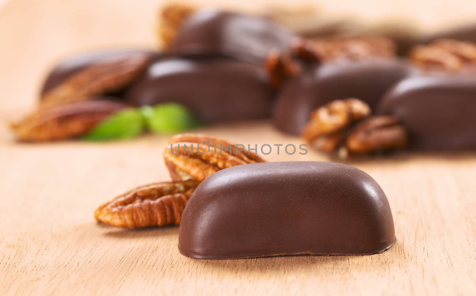 Chocolate candies filled with pecan nut (Very Shallow Depth of Field, Focus on the front of the candy)