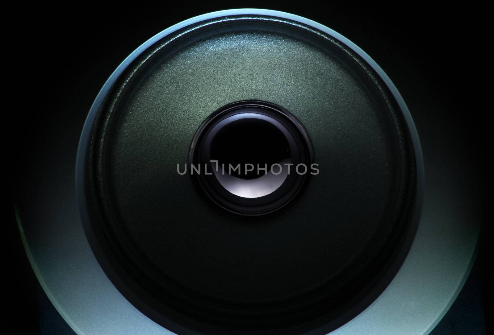 close up of a dark loudspeaker with light effect