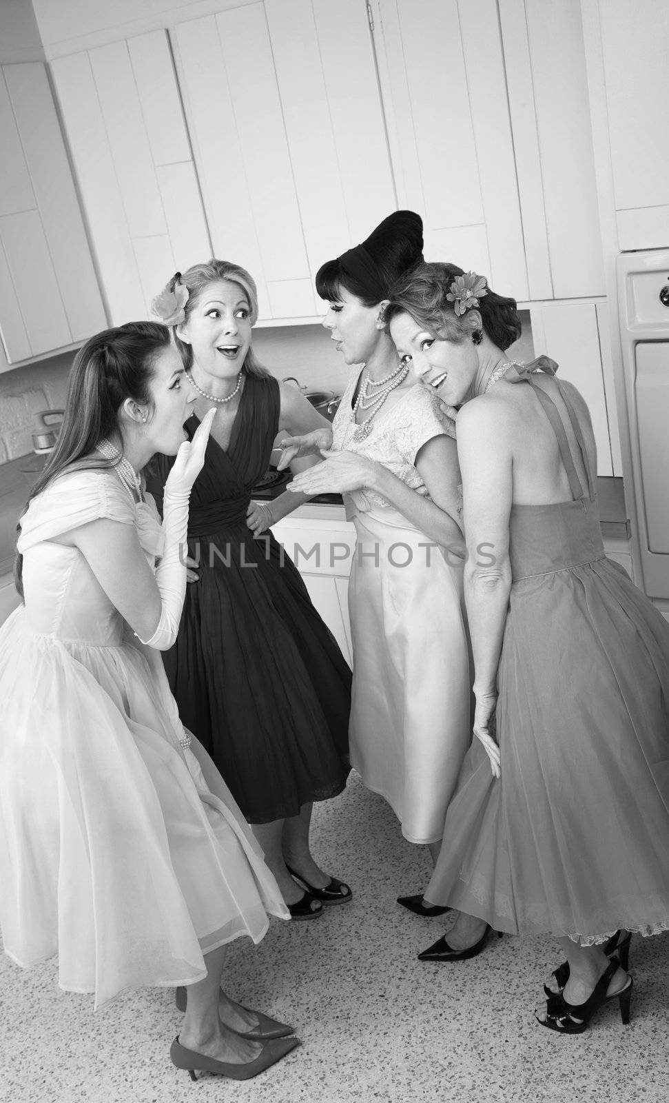 Group of four retro-styled women gossip in a kitchen 