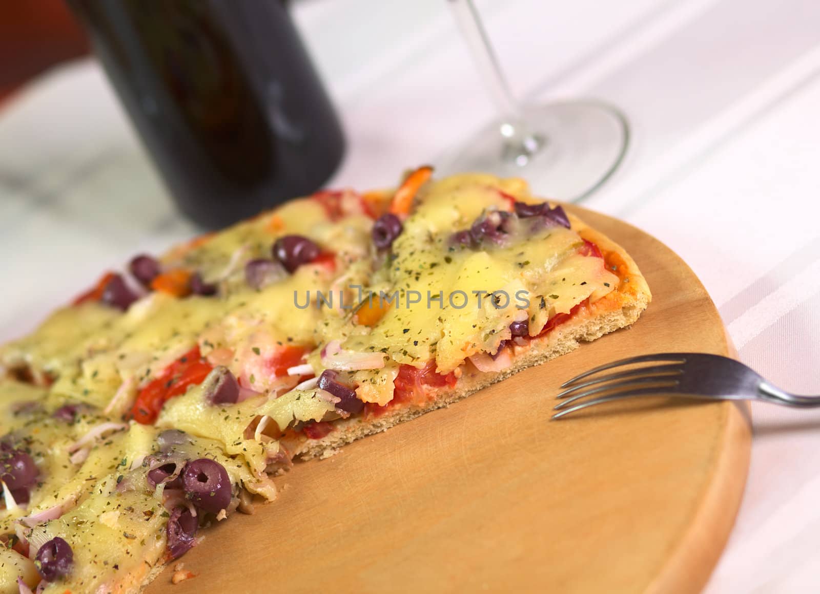 Pizza on Wooden Plate by ildi