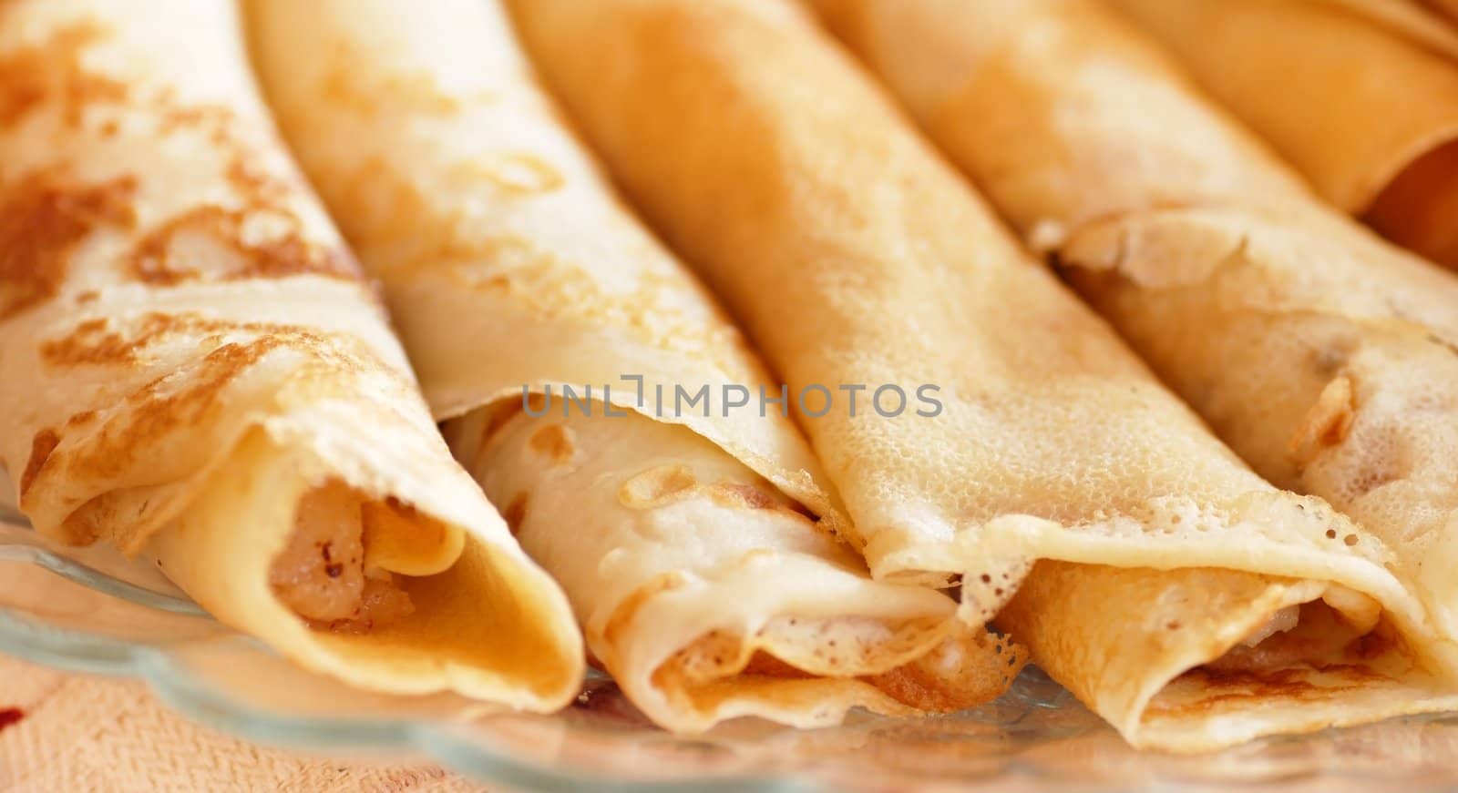 several appetizing rolled pancakes closeup on table