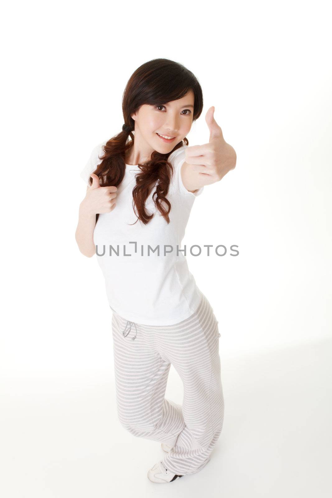 Young beauty give you double excellent gesture, full length portrait in studio white background.