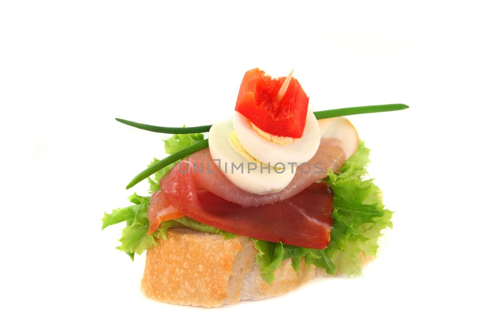 a baguette slice with bacon and quail eggs
