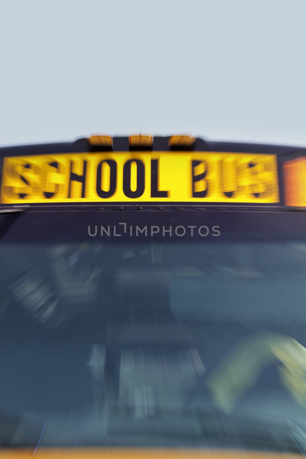 Front of yellow school bus in motion