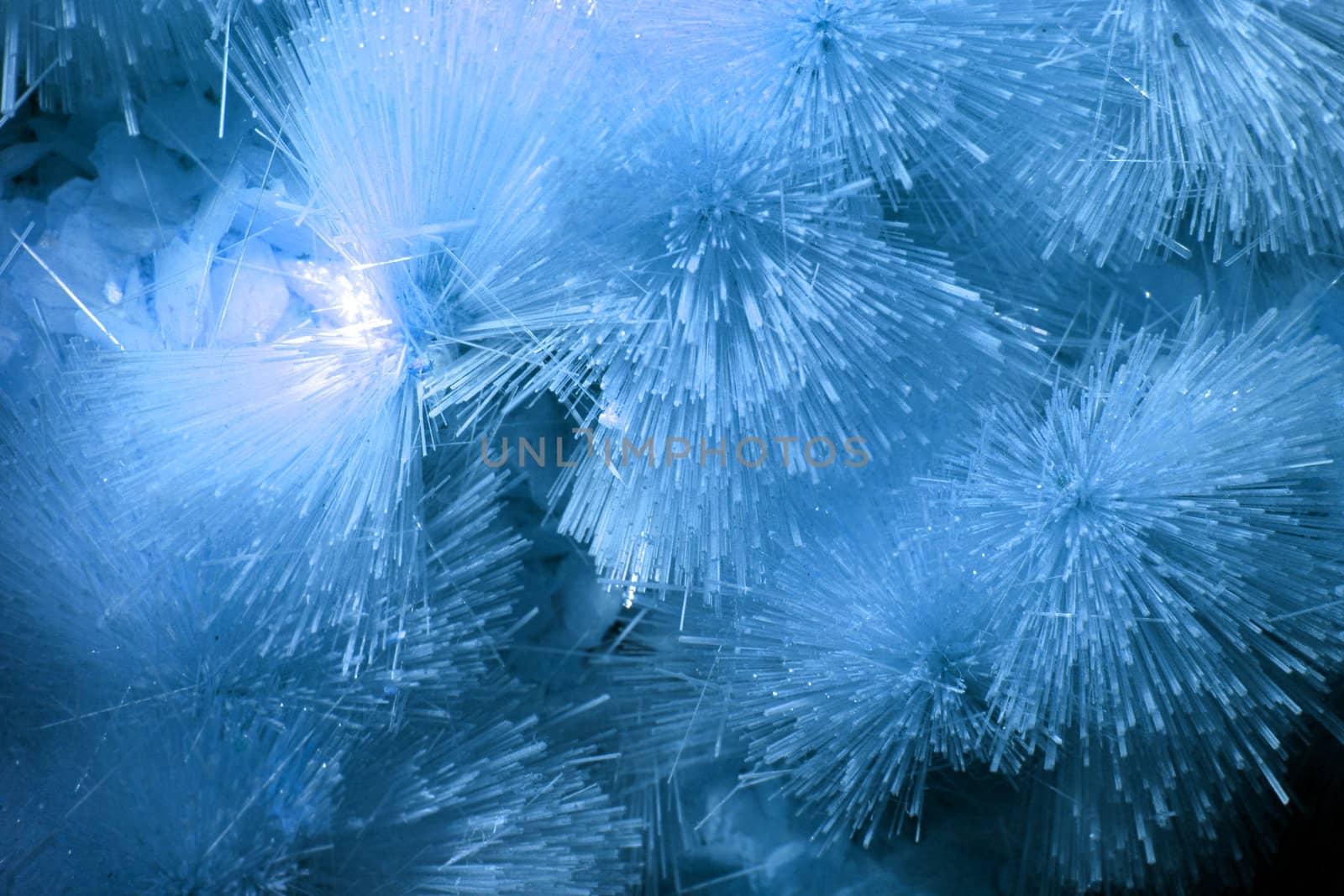 A background of blue crystallized forms in a cave.