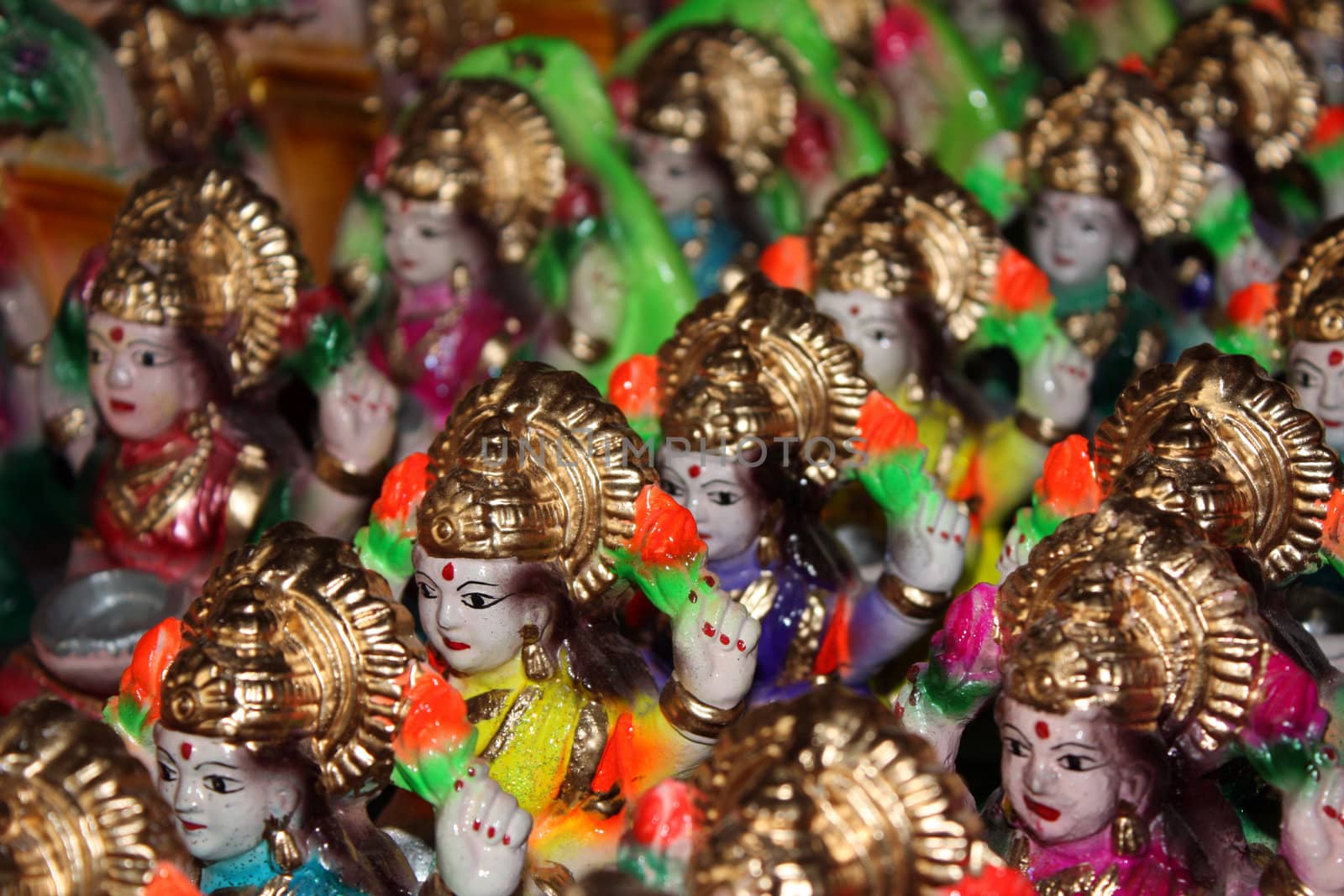 A background of small clay idols of hindu wealth goddess Laxmi.