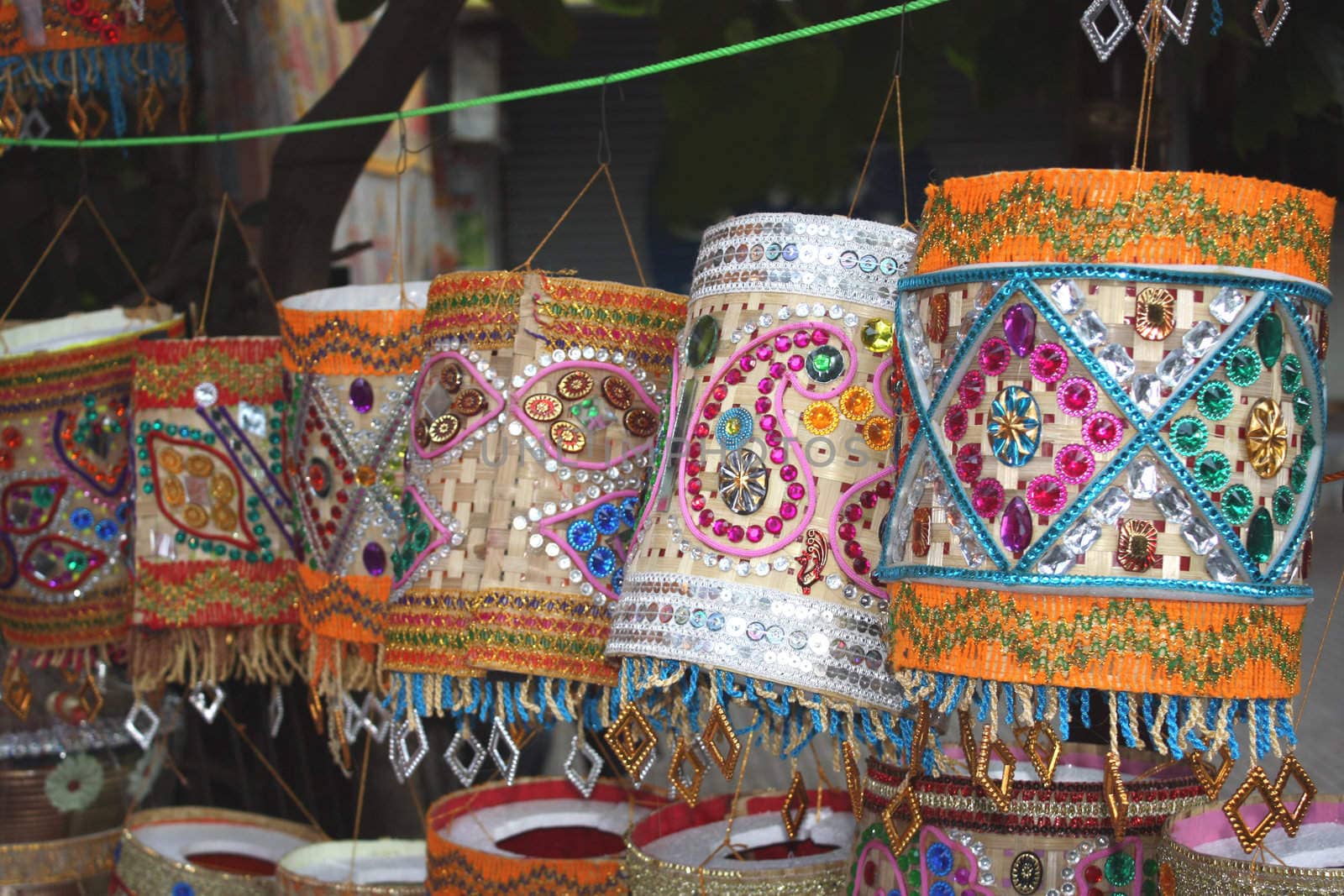 Lanterns of different traditional Indian designs hung outside a shop on the occassion of a festival in India.