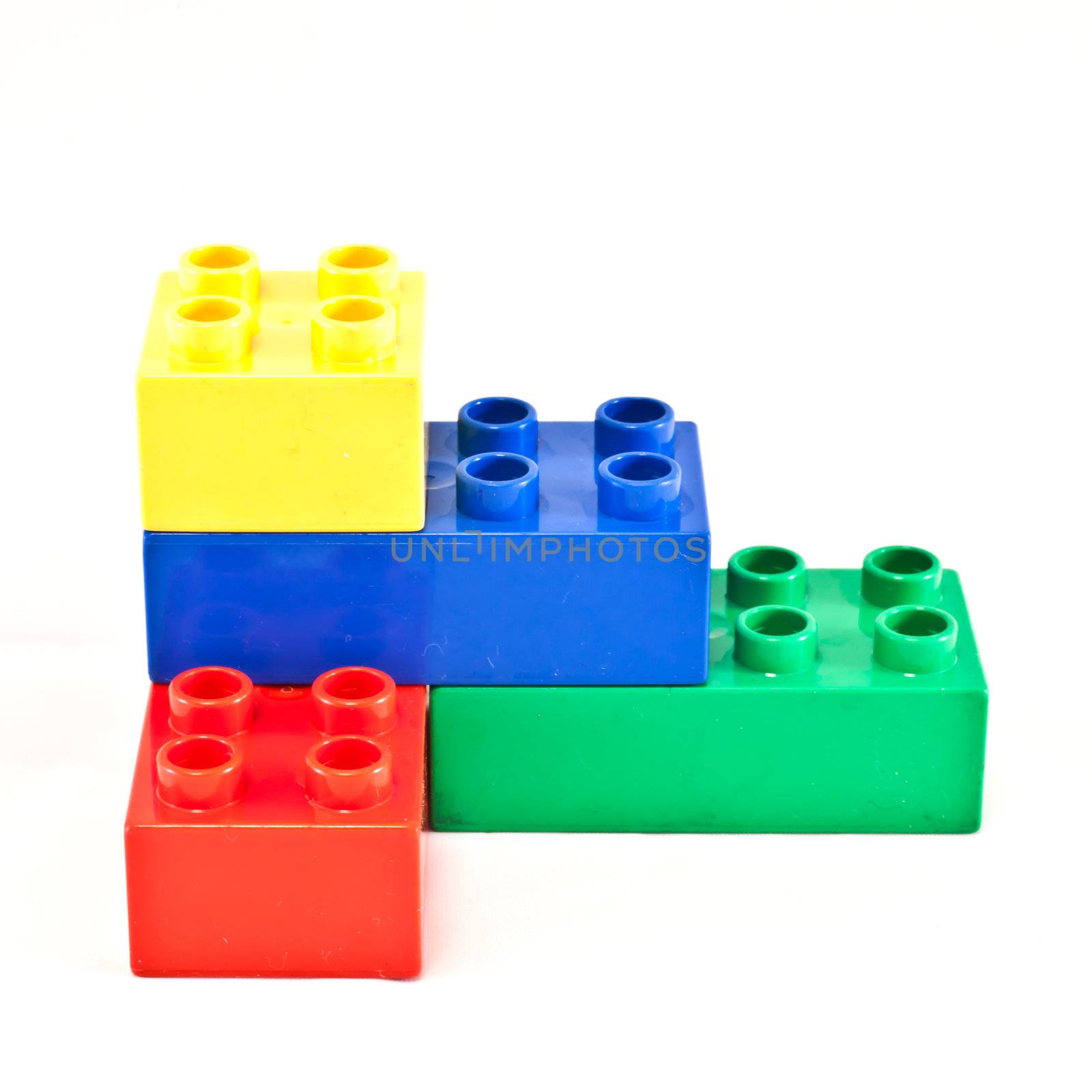 Plastic building blocks on white background. Bright colors.