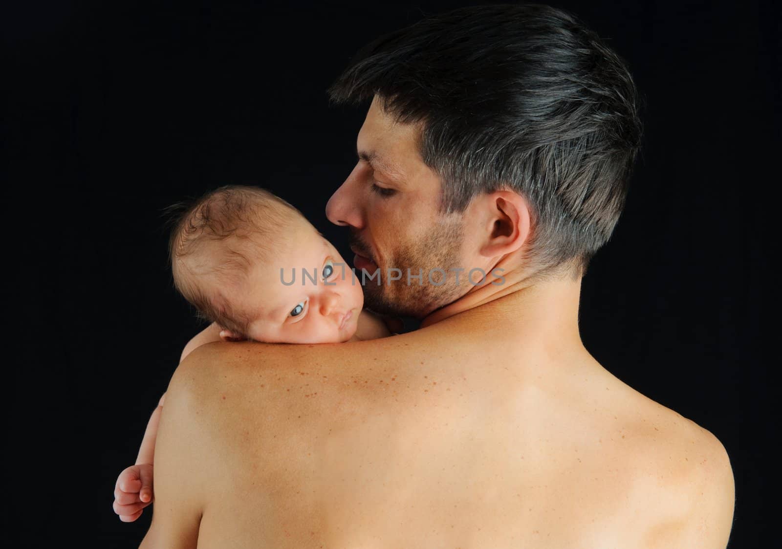 Father holding newborn baby. Portrait of a newborn boy closeup