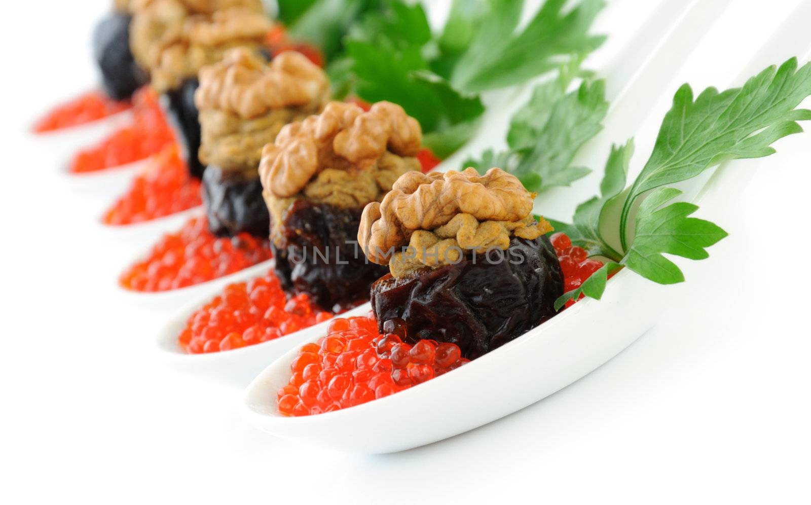 Prunes stuffed with liver pate with nuts in a red caviar