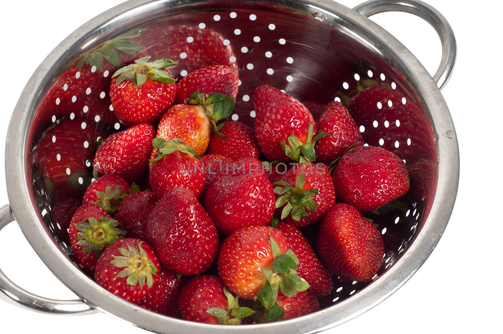 Shot of strawberries in strainer isolated on white