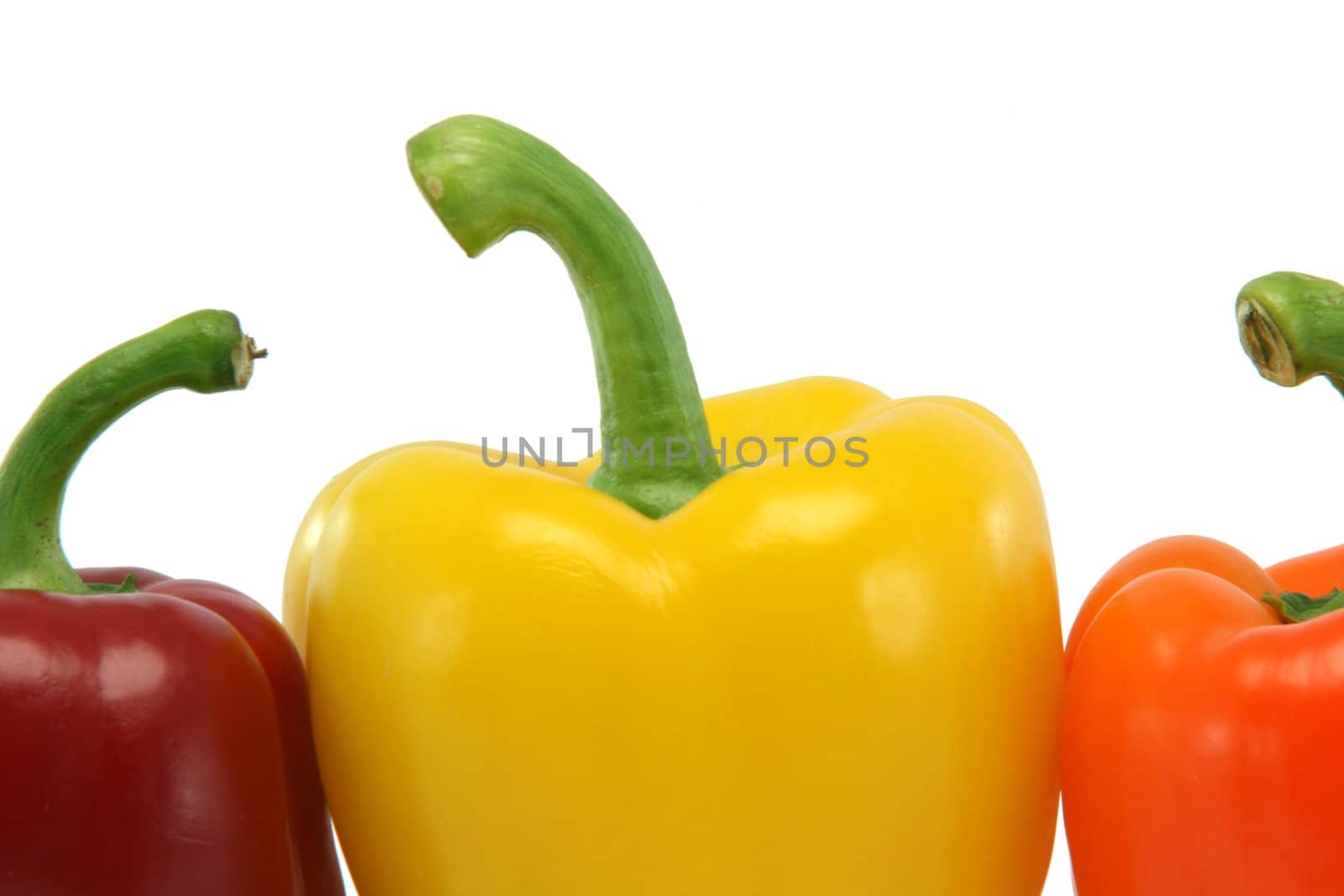 detail from three color peppers isolated on white background food and vegetables concepts