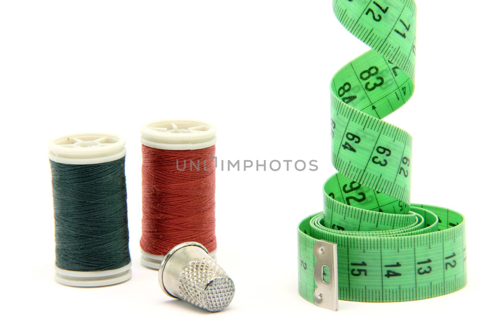 sewing items measure tape cotton strings and thimble isolated on white background