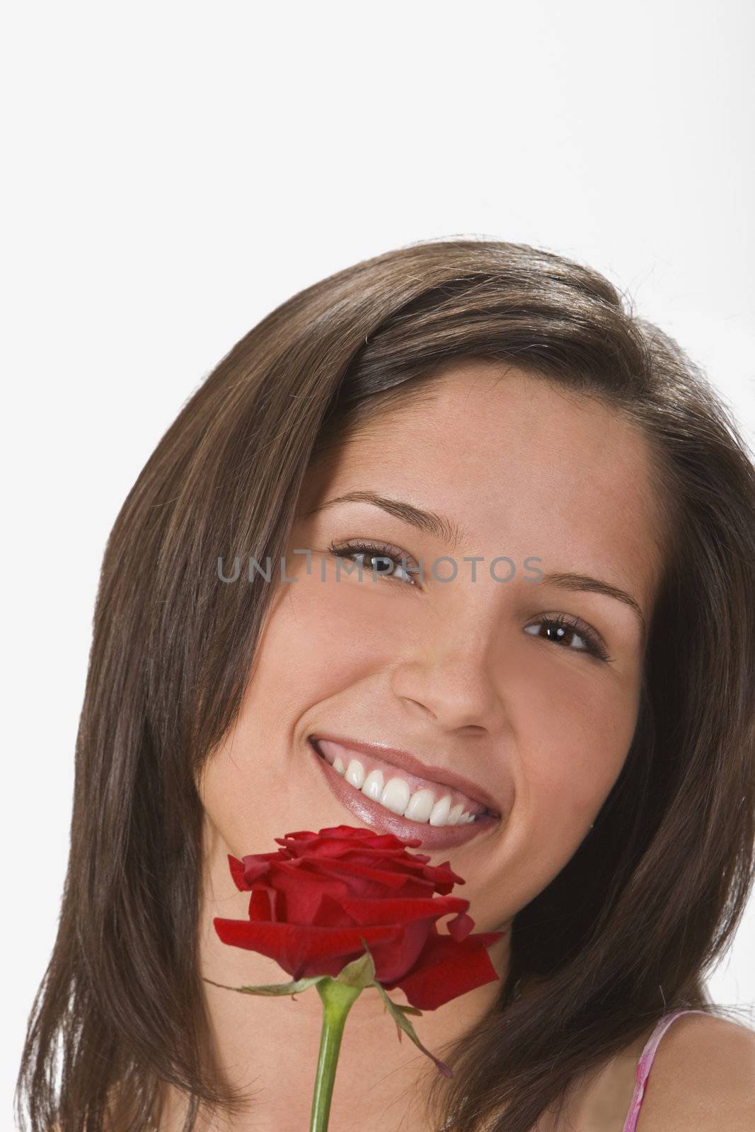 Beautiful young brunette smilling and holding a rose.