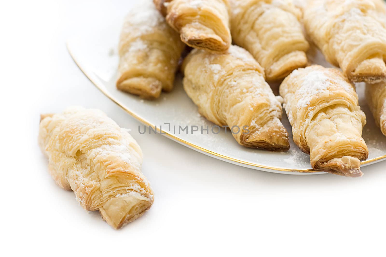 Small french croissants sugar powdered over white