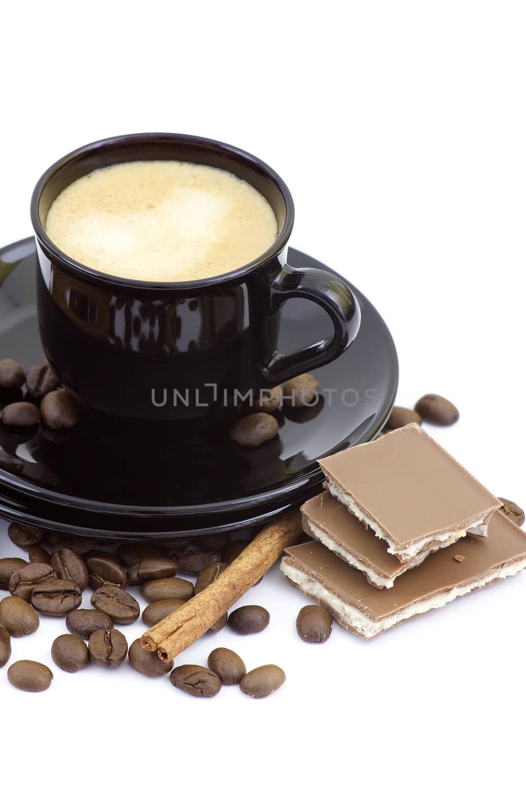 cup of italian espresso with cinnamon, coffee beans and chocolate