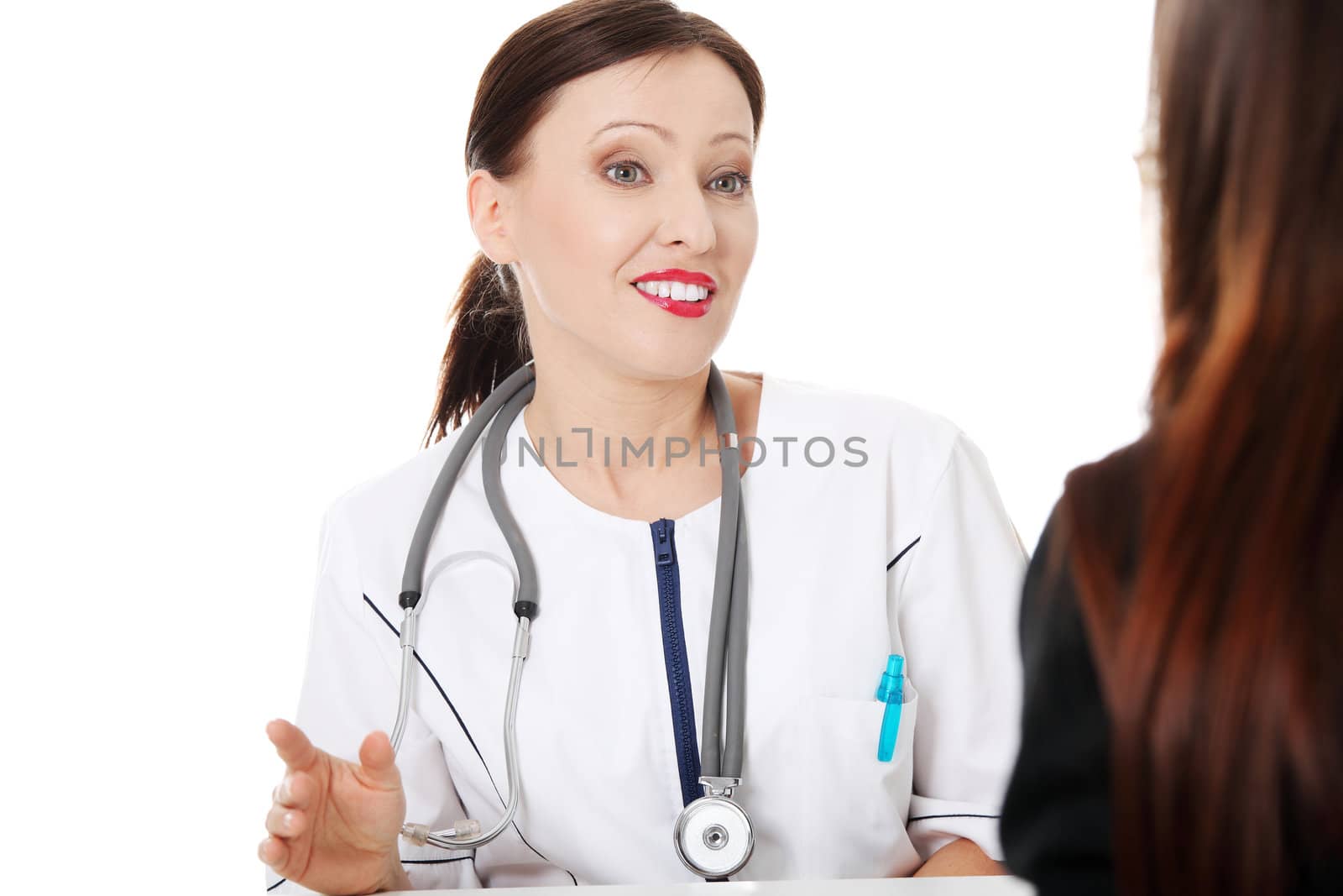 Mature female doctor with her patient.