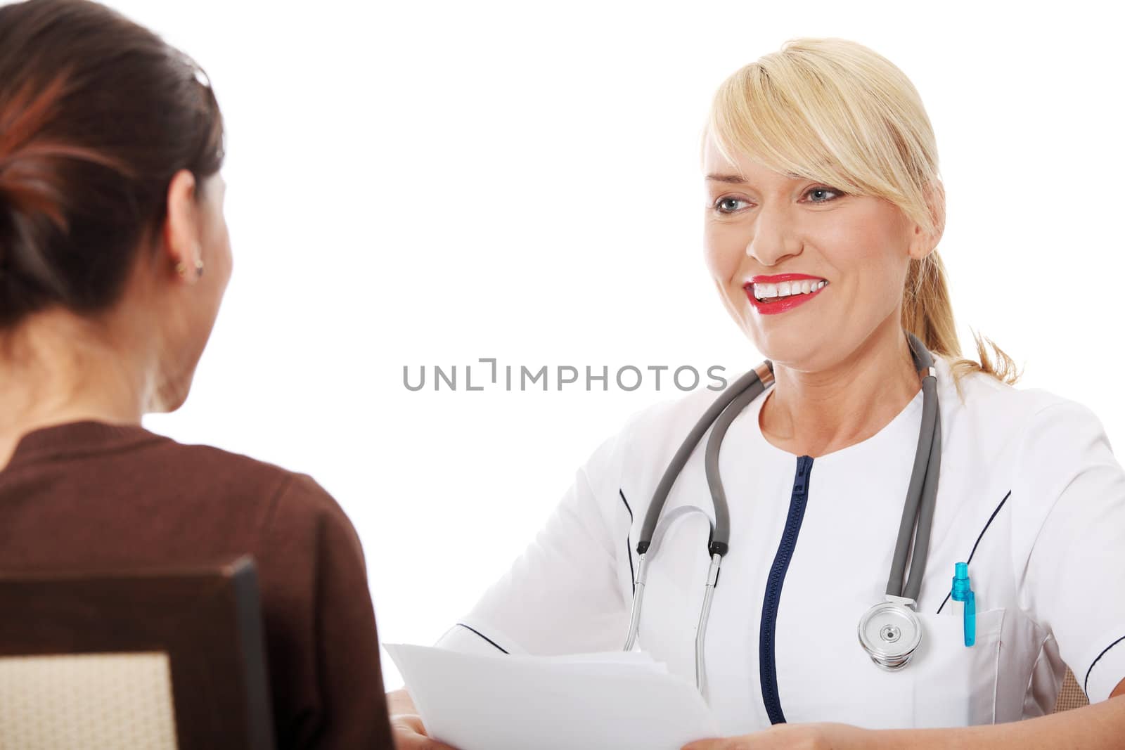 Mature female doctor talking with patient. by BDS