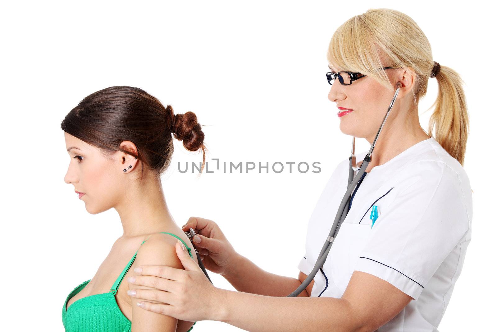 Mature female doctor examining with female patient.