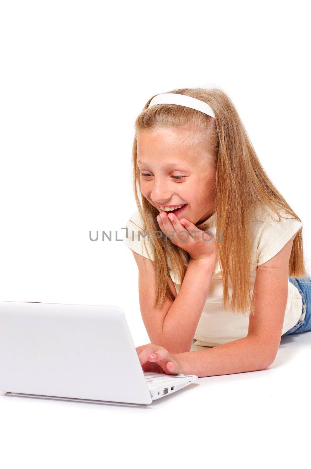 Happy and smiling little girl with laptop on white background isolated