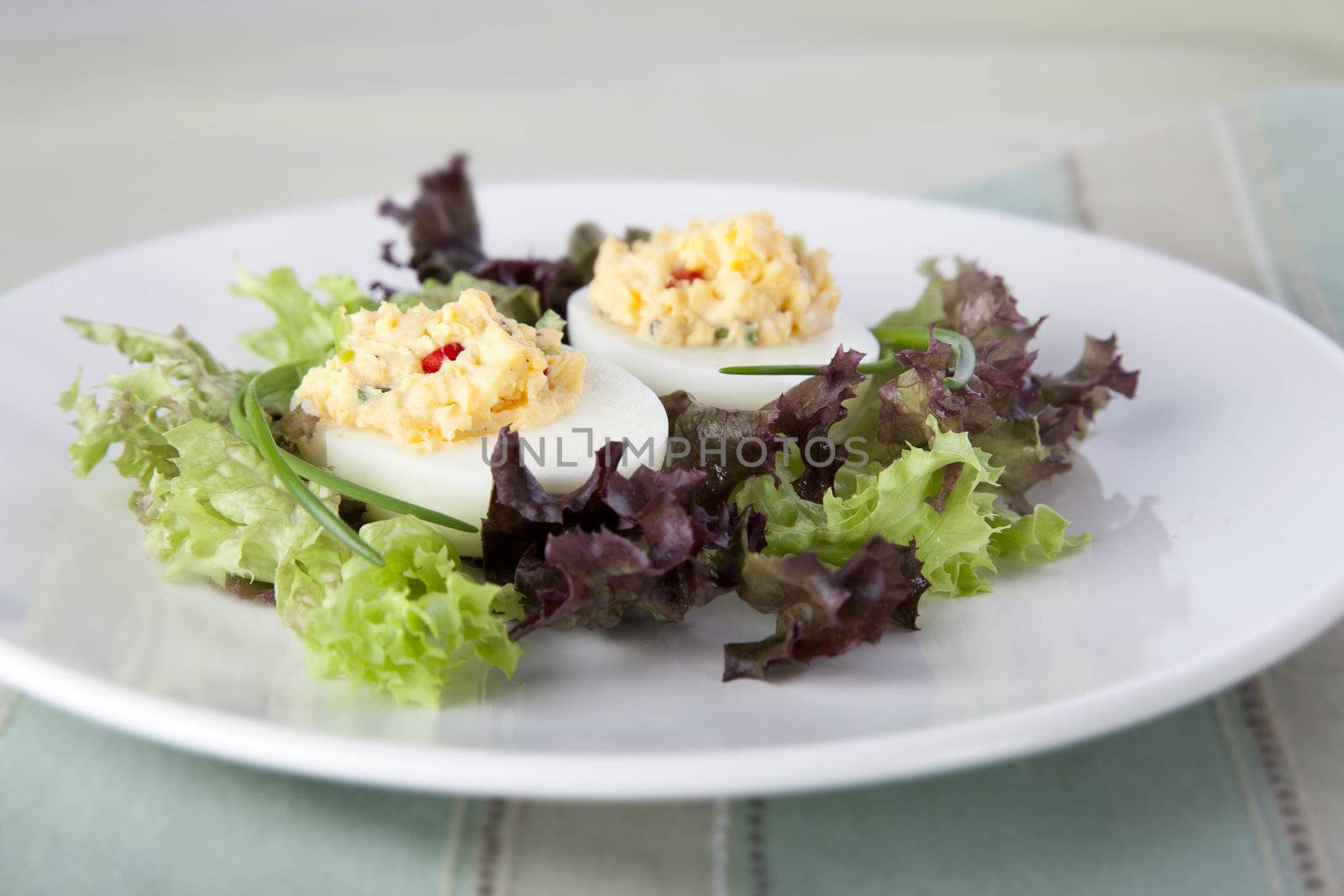 Gourmet deviled eggs in a bed of lettuce.