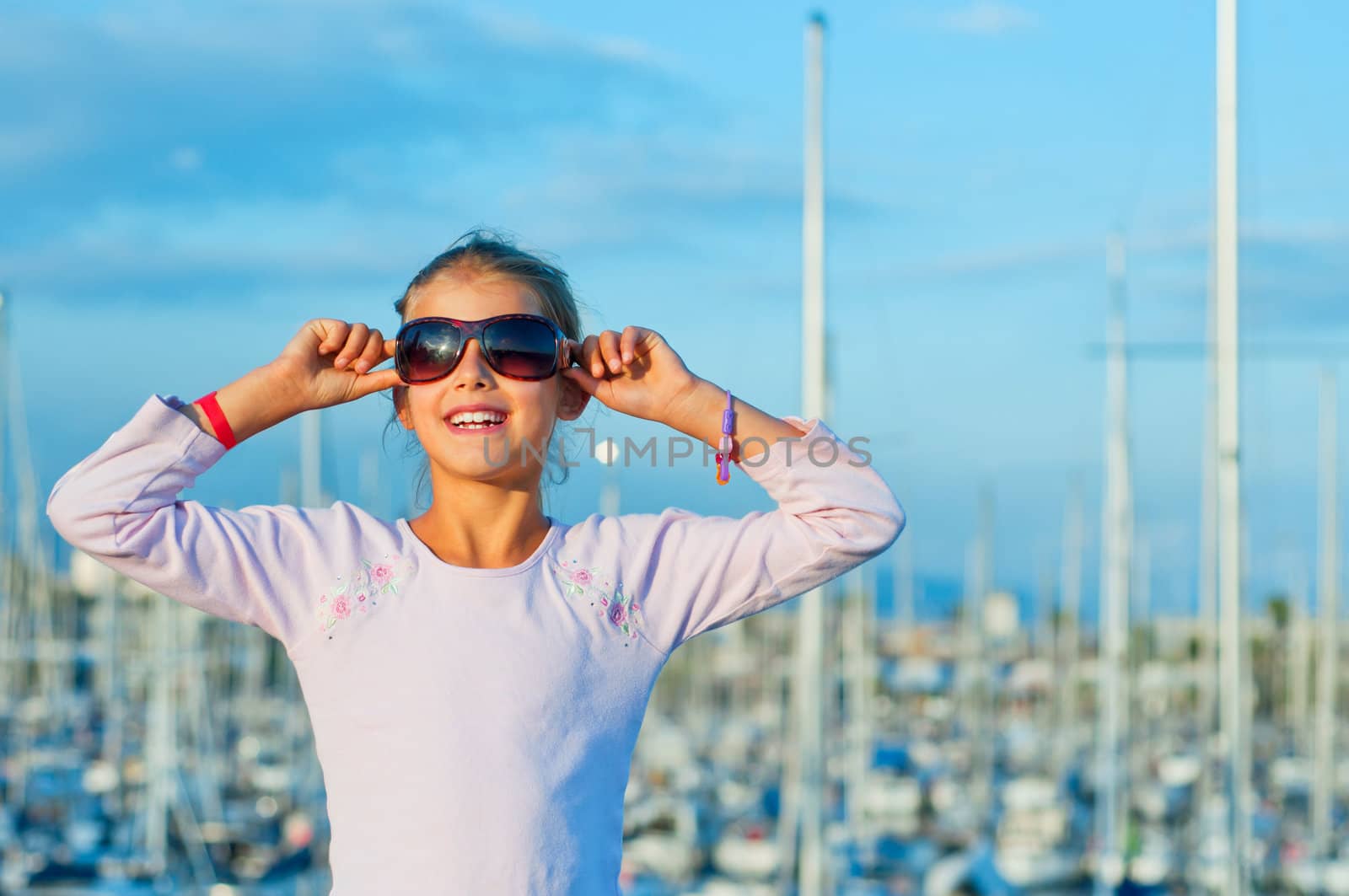 Closeop Portrait of a cute girl in the background of yachts