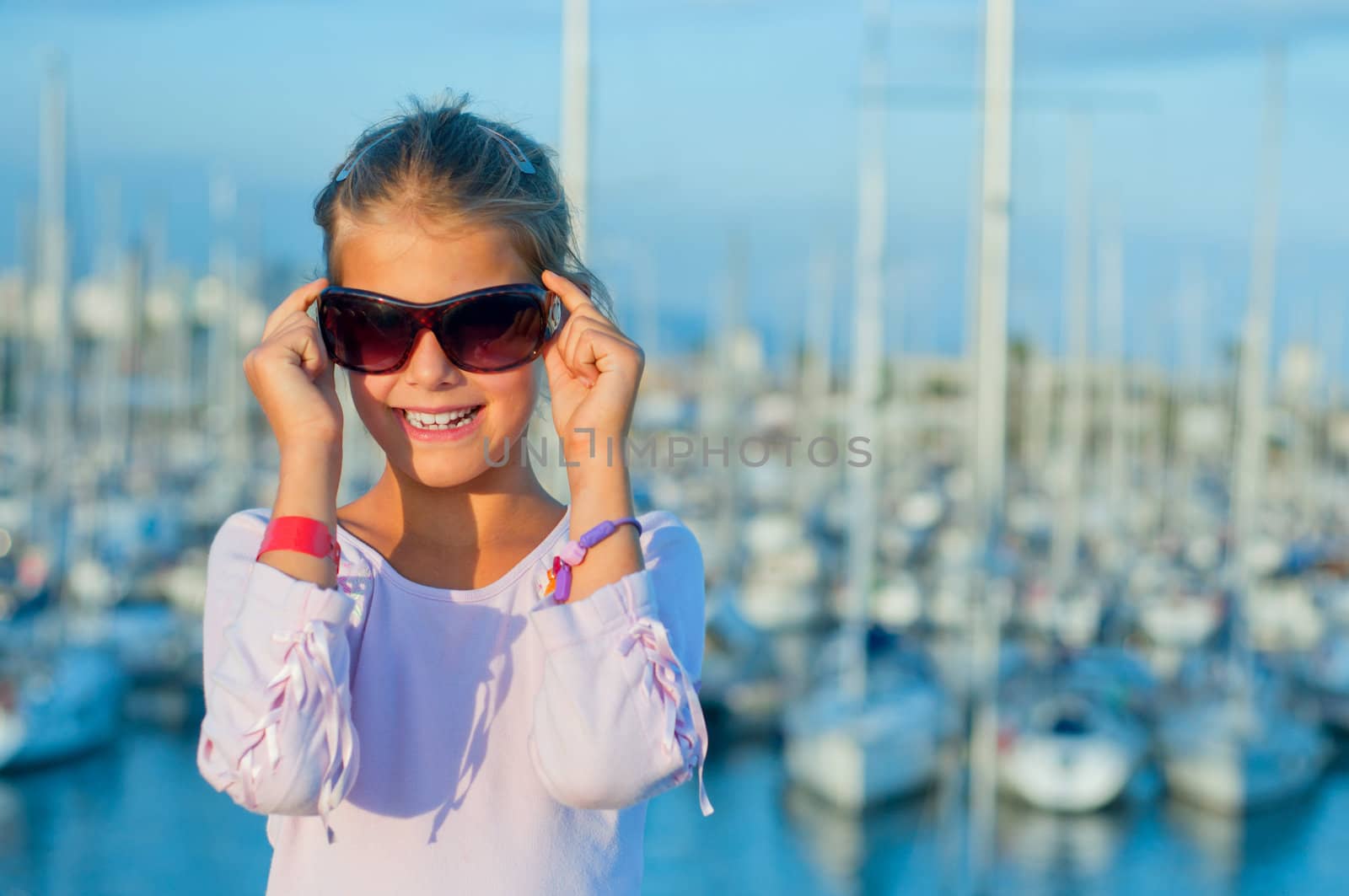 Closeop Portrait of a cute girl in the background of yachts