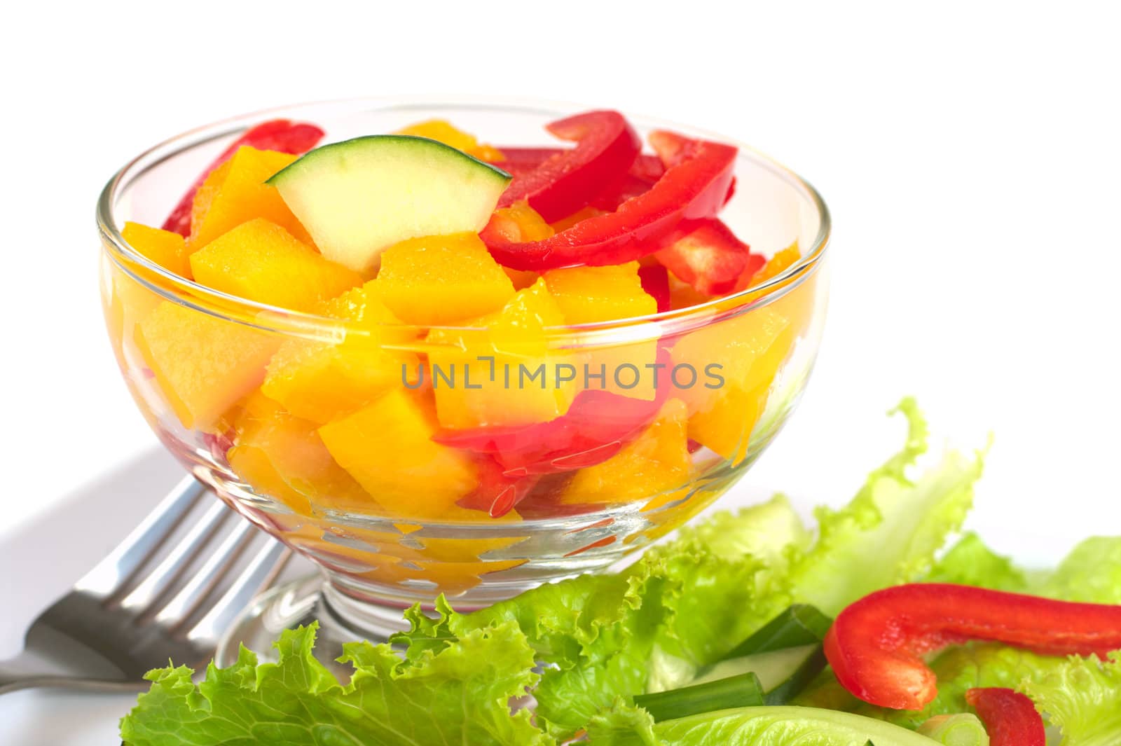 Fresh salad of mango, red bell pepper, cucumber and lettuce (Selective Focus, Focus one third into the bowl)