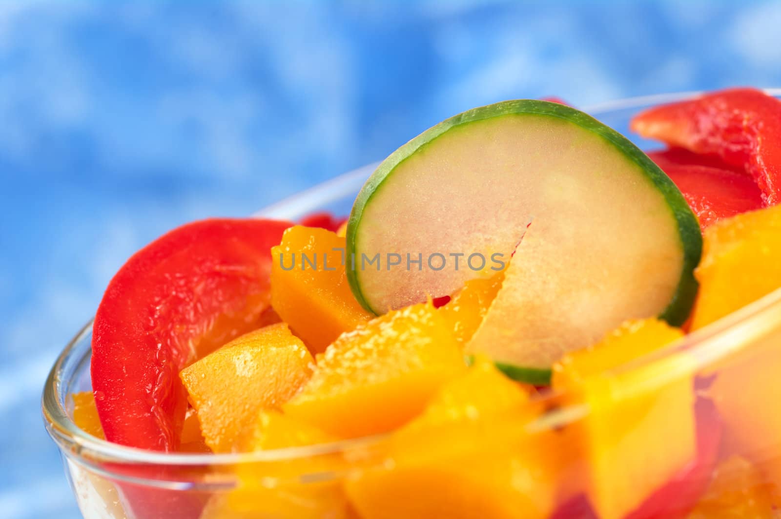 Fresh salad of mango, red bell pepper and cucumber (Very Shallow Depth of Field, Focus on the upper edge of the cucumber)