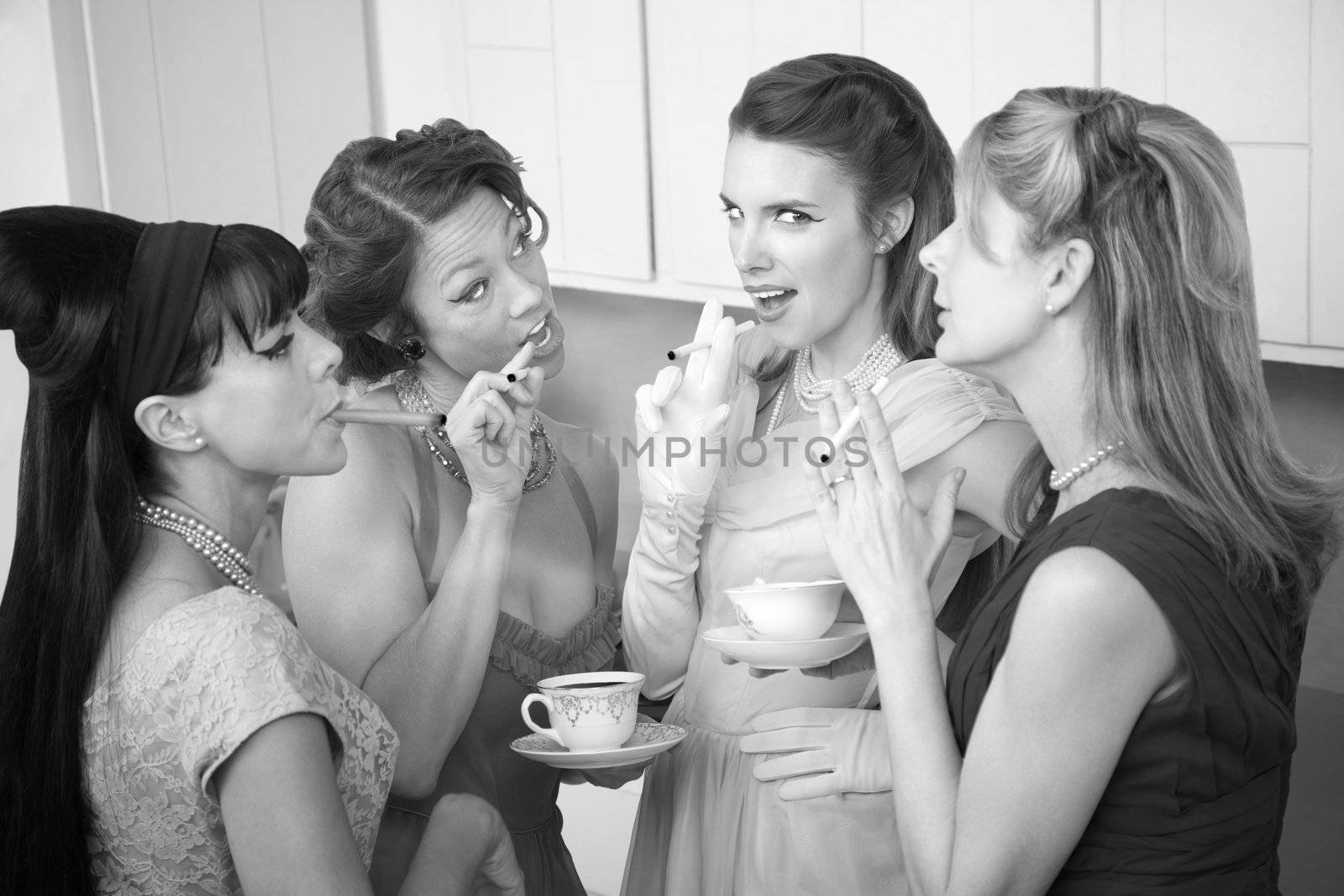 Four retro-styled women smoking cigarettes and drinking coffee in a kitchen