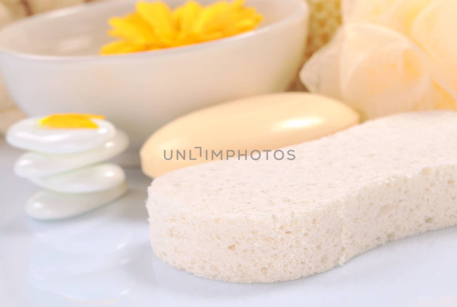 Spa still life with sponge, flower and soap (Selective Focus, Focus on the front of the sponge)