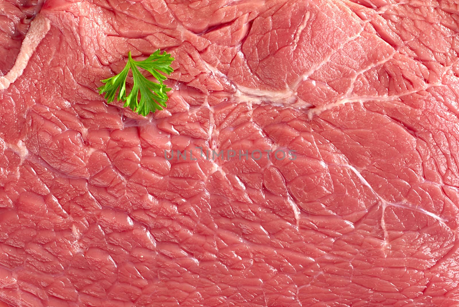 Texture and surface of fresh raw beef meat garnished with parsley
