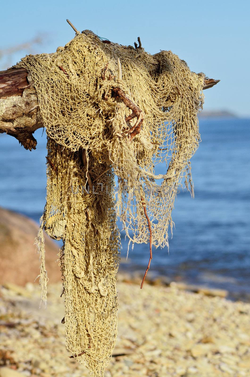 Old broken fishing nets on the seacoast