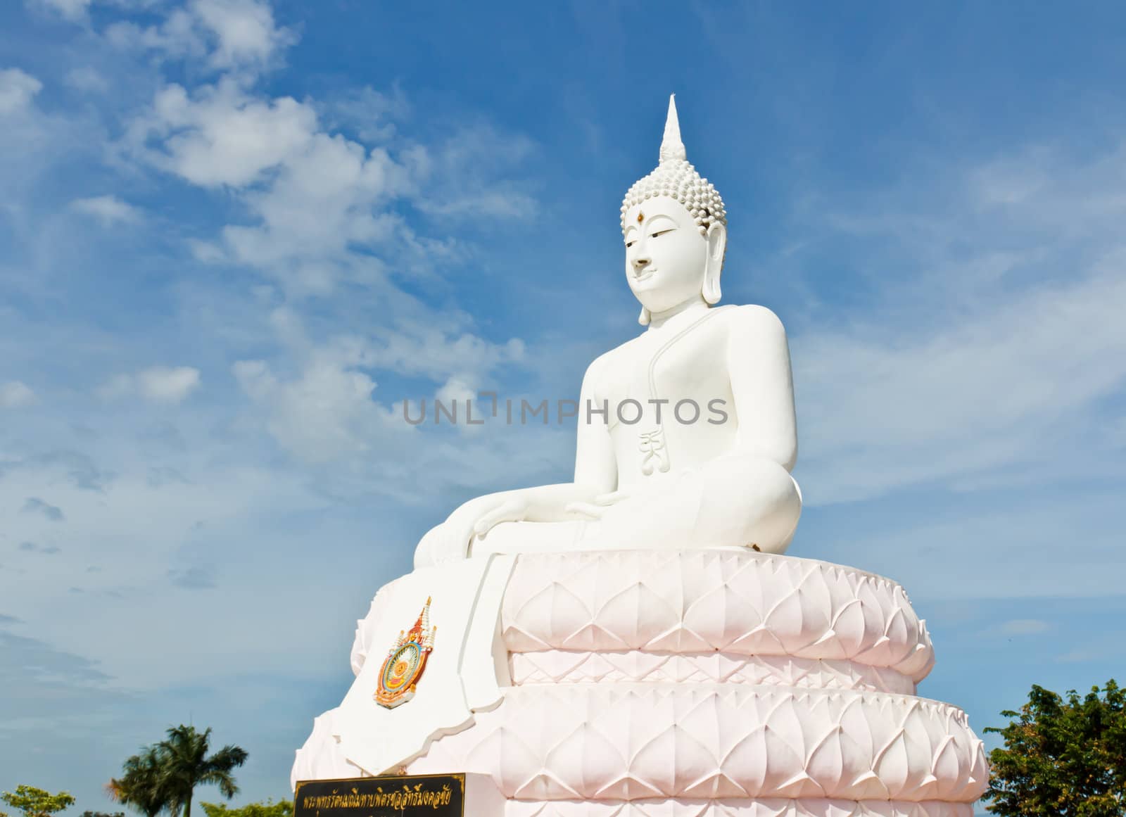 White Buddha statue with blue sky.