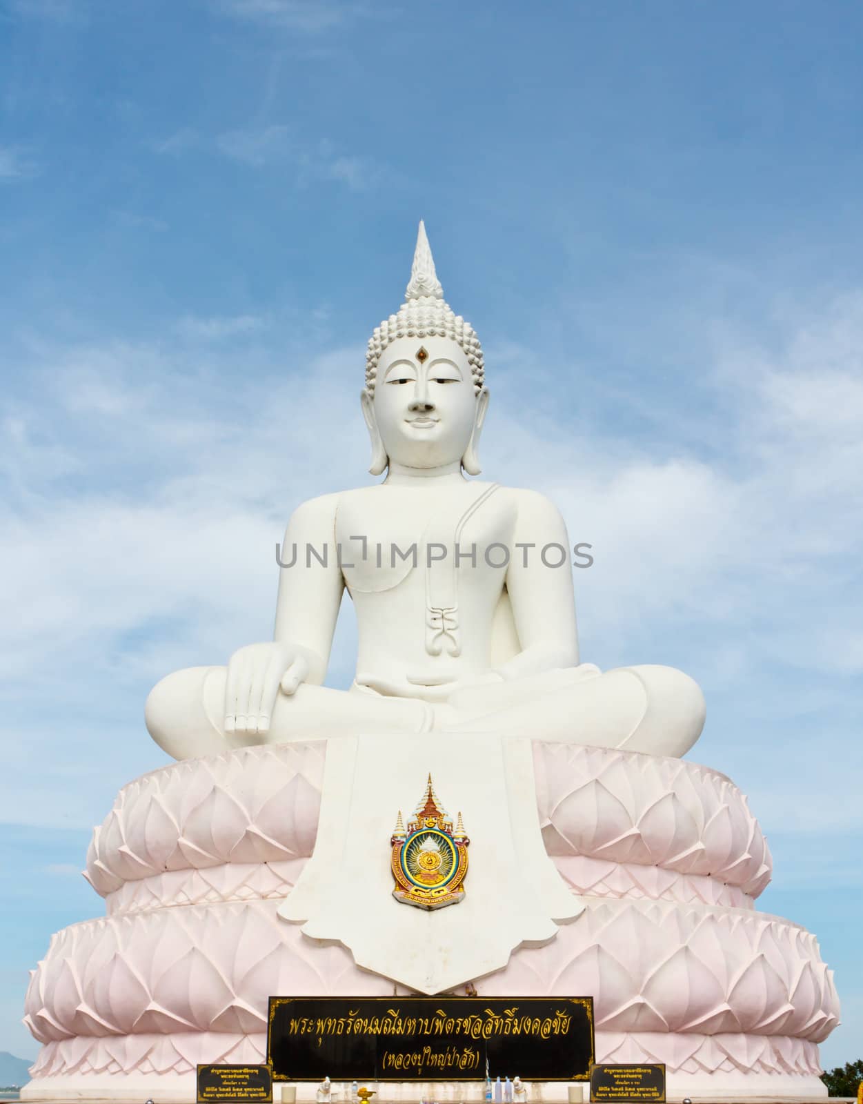 White Buddha statue with blue sky.