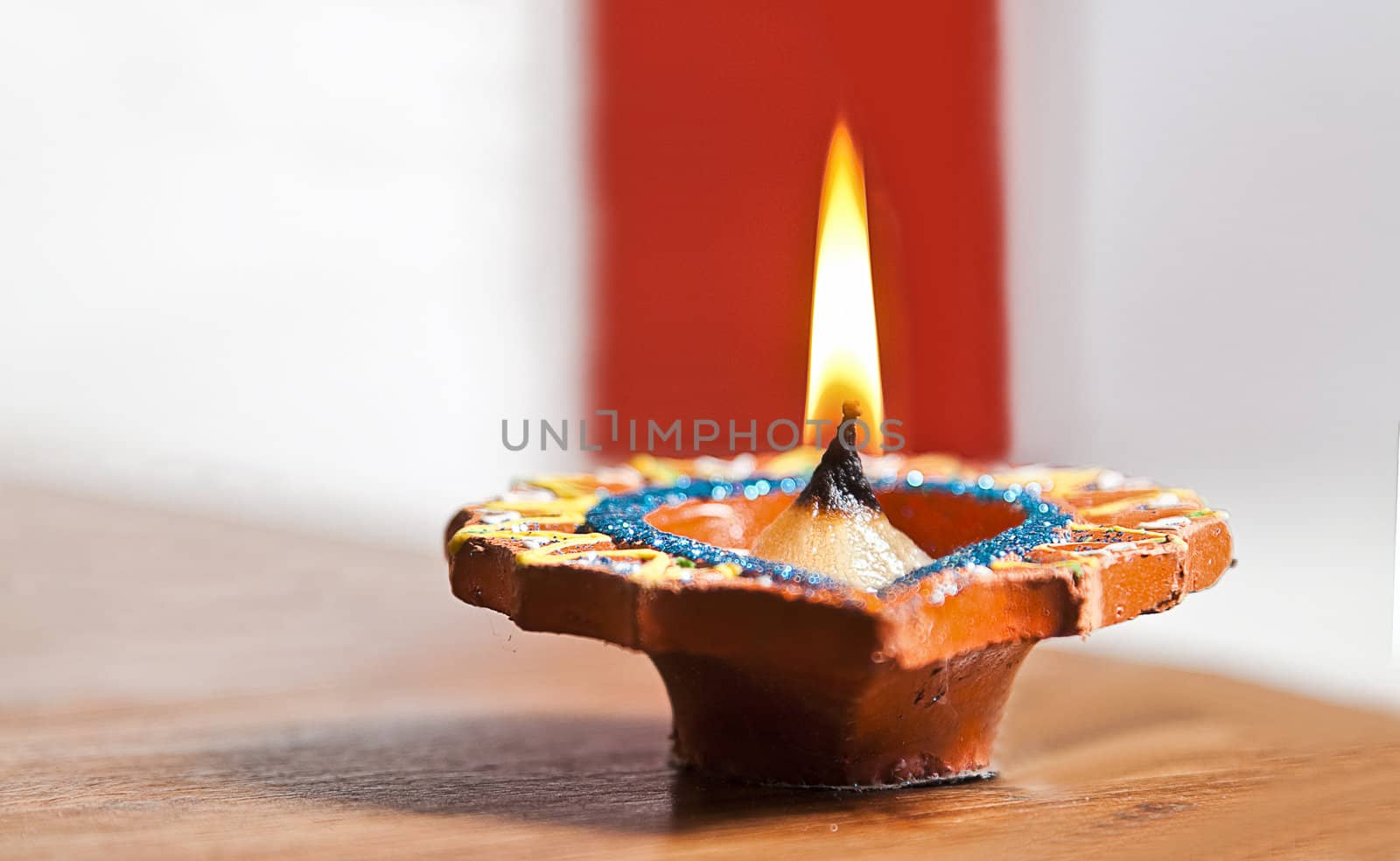 festival oil lamp with a red strip fazed in the background