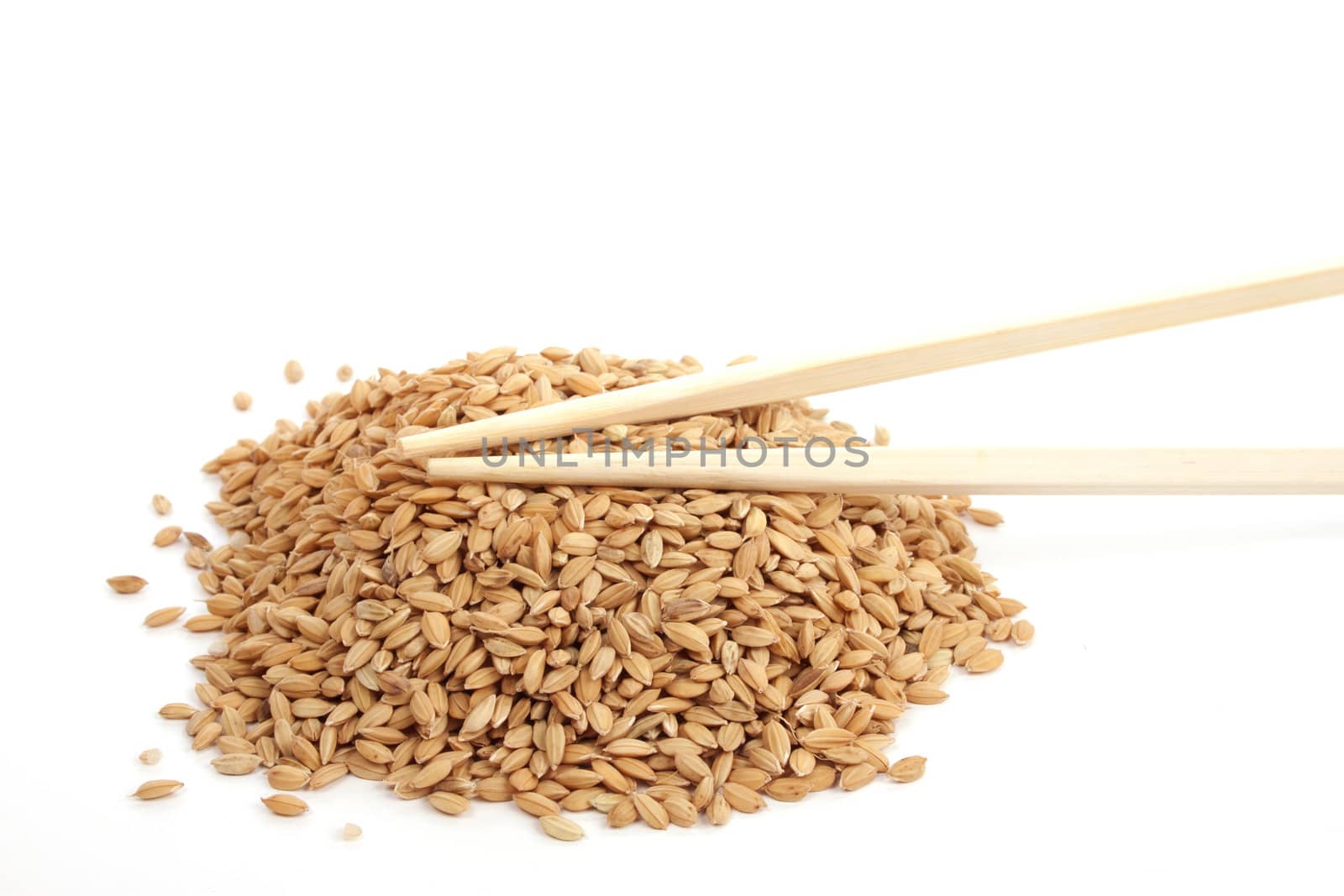 Unpeeld rice against a white background