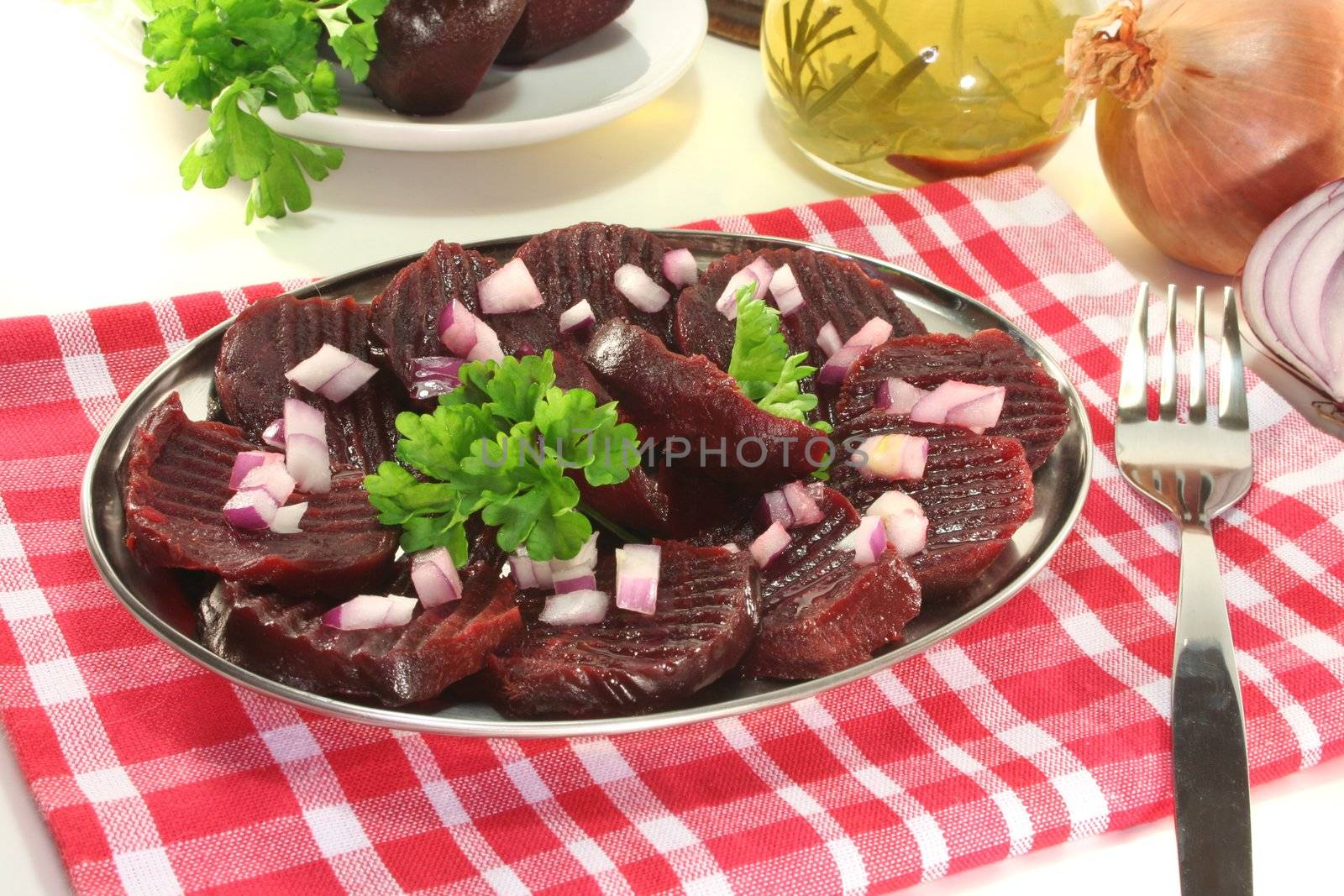 red beet root salad with red onions and parsley on a white background
