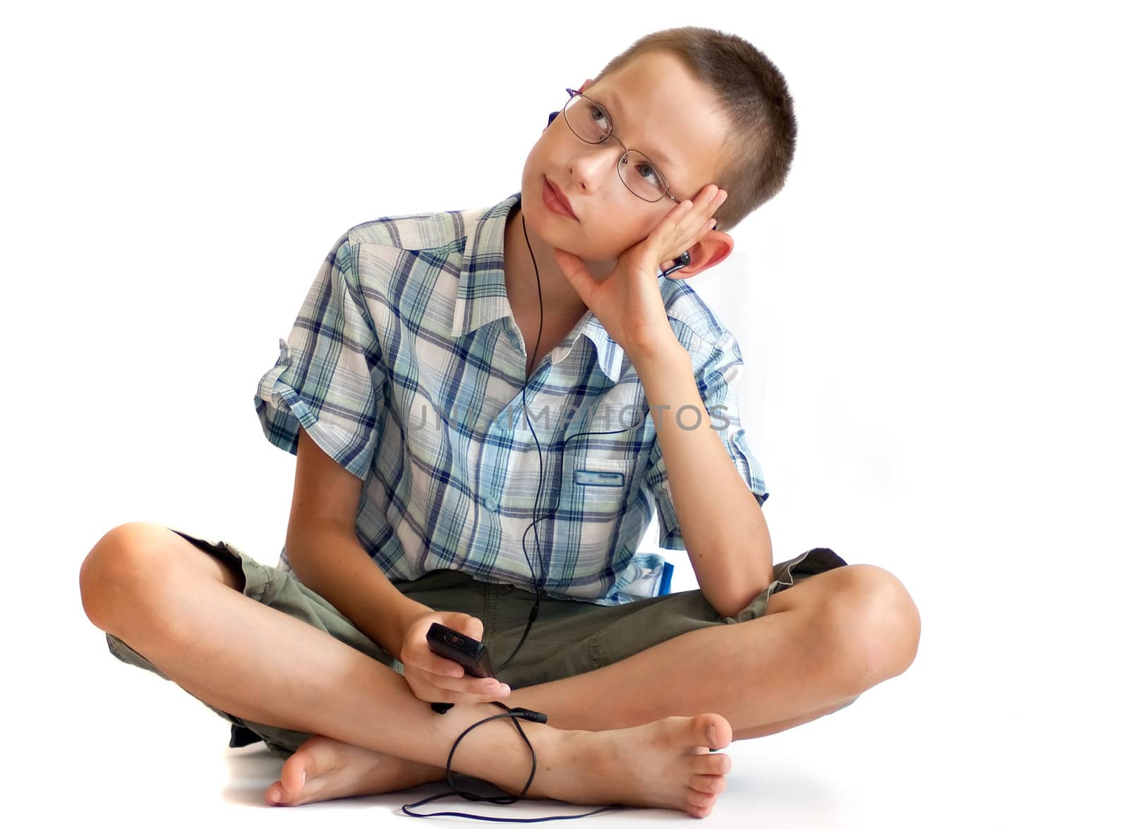 Boy listening music on an mp3 player or phone by vasily